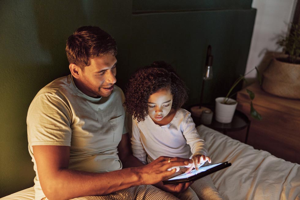 Father and child looking at a tablet device.